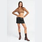 Emory Park long sleeve cropped vacation top in sheer brown paired with a black denim skirt