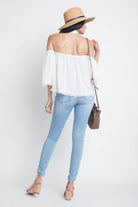 Ivory Felix long sleeve vacation top in white with off-shoulder design and lace trim, perfect for summer outings