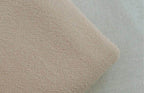 Soft fabric texture of loose fit mens vacation pants in a light beige color by VacationGrabs