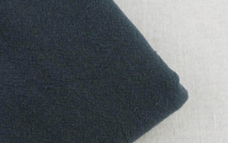 Soft fabric texture of loose fit men's vacation pants by VacationGrabs in dark color