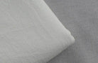 Close-up of soft fabric for loose fit men's vacation pants in light gray and white