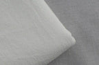 Close-up of soft fabric for loose fit men's vacation pants in light gray and white