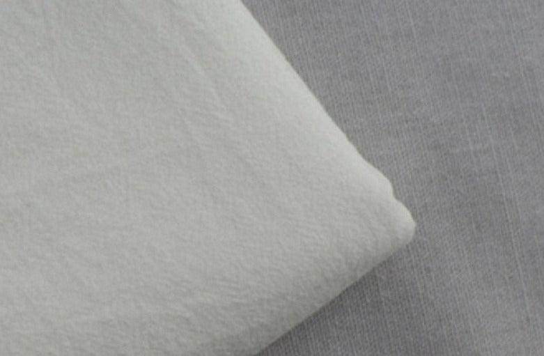 Close-up of soft fabric for loose fit men's vacation pants in light gray and white