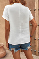 Back view of a loose ruched tank top for women paired with distressed denim shorts