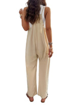 Loose sleeveless jumpsuit for women in beige, featuring a relaxed fit and back tie detail