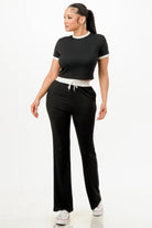 Stylish women's ribbed contrast binding lounge set in black with a cropped top and relaxed pants