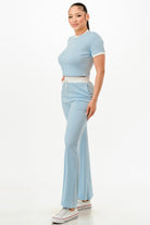 Women's ribbed contrast binding lounge set in light blue with a stylish cropped top and flared pants