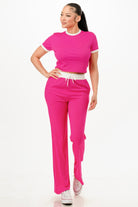 Women's ribbed contrast binding lounge set in vibrant pink, featuring a cropped top and loose pants