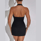 Back view of a woman wearing a black low-cut evening dress for women with halter neck and fitted silhouette