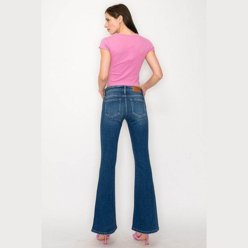 Back view of a woman wearing Artemis Vintage low rise stretch jeans for women with flared legs