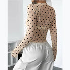 Miss Sparkling beige polka dot see through mesh crop top back view with white cargo pants
