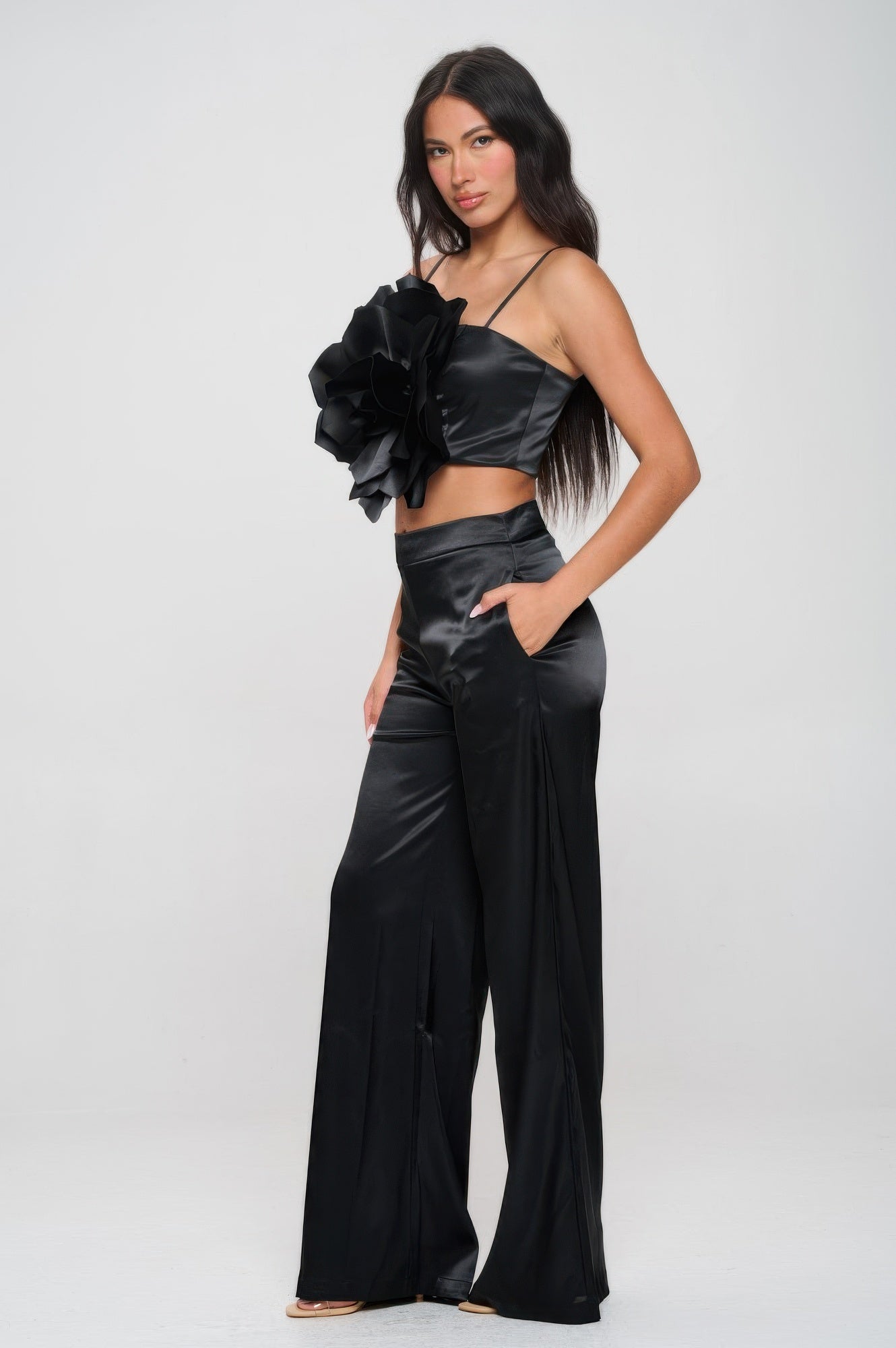 Women wearing black satin two-piece vacation outfit for women with ruffle top and wide-leg pants