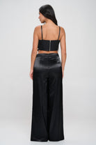 Women's black satin two-piece set featuring a cropped top and wide-leg pants vacation outfit for women