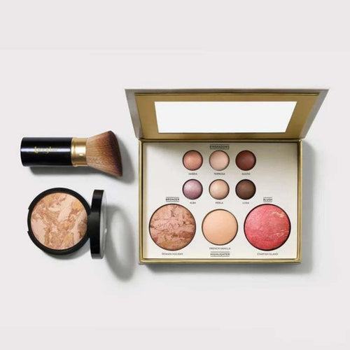 Travel-friendly makeup palette with blushes, bronzer, and a brush