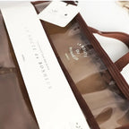 Transparent makeup bag cosmetic with brown accents, ideal for travel