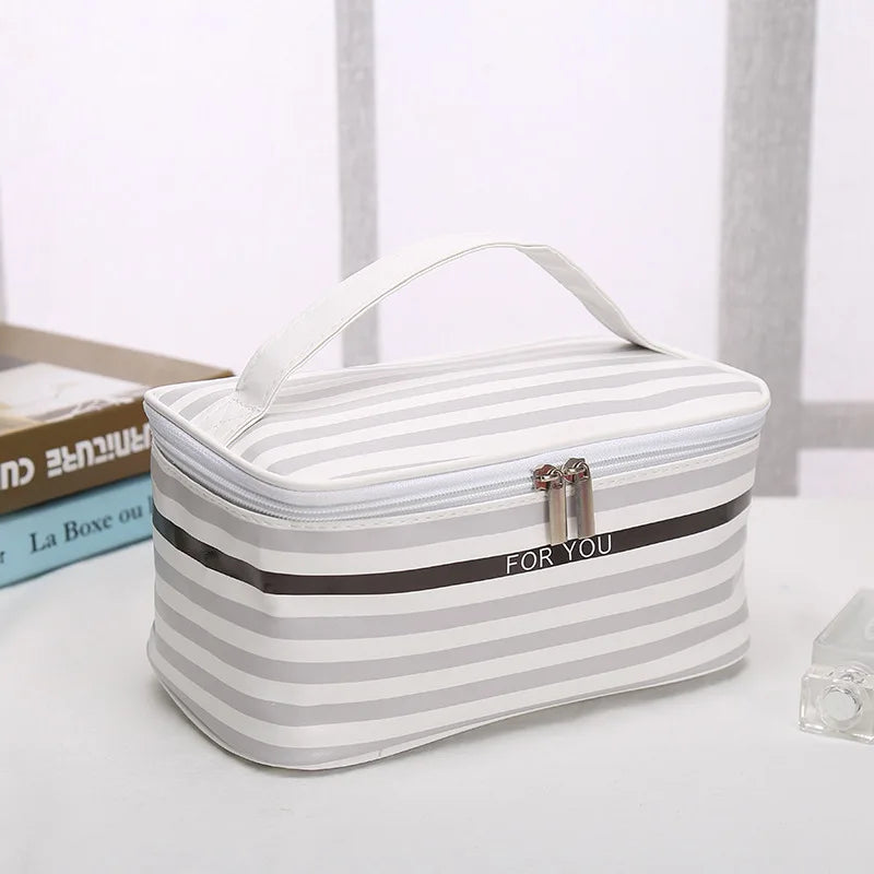 Striped makeup bag cosmetic in gray and white, ideal for travel storage