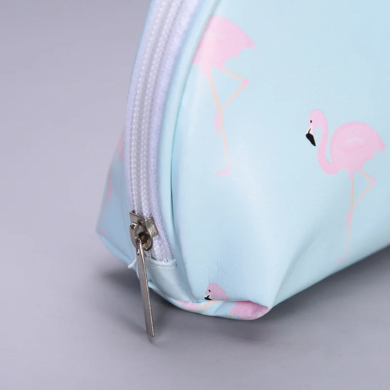 Light blue makeup bag with pink flamingo design, perfect for travel