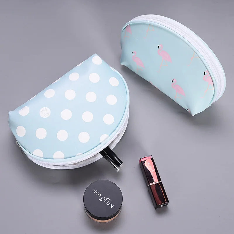 Light blue makeup bag with polka dots and flamingo print for travel