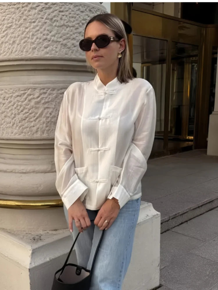 Women's white silk blouse featuring a mandarin collar, perfect for casual outings