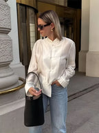 Women's white blouse with mandarin collar, styled for casual outings