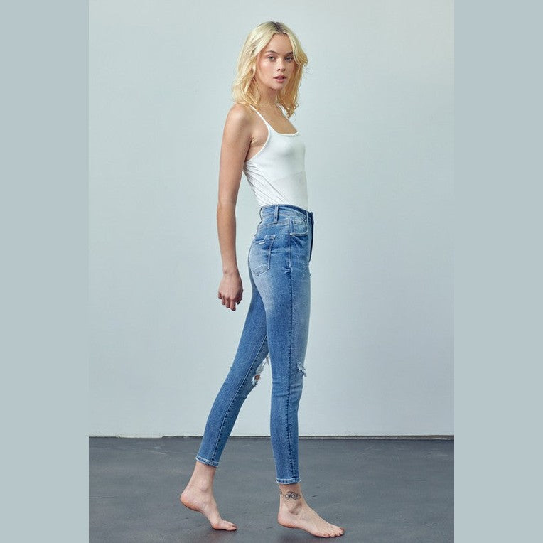 Insane Gene women's trendy skinny jeans for travel in light blue denim styled with a white tank top