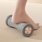 Gray manual foot massager roller for relaxing foot therapy
