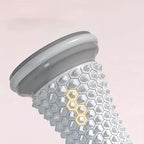 Gray manual foot massager roller with textured grip for relaxation