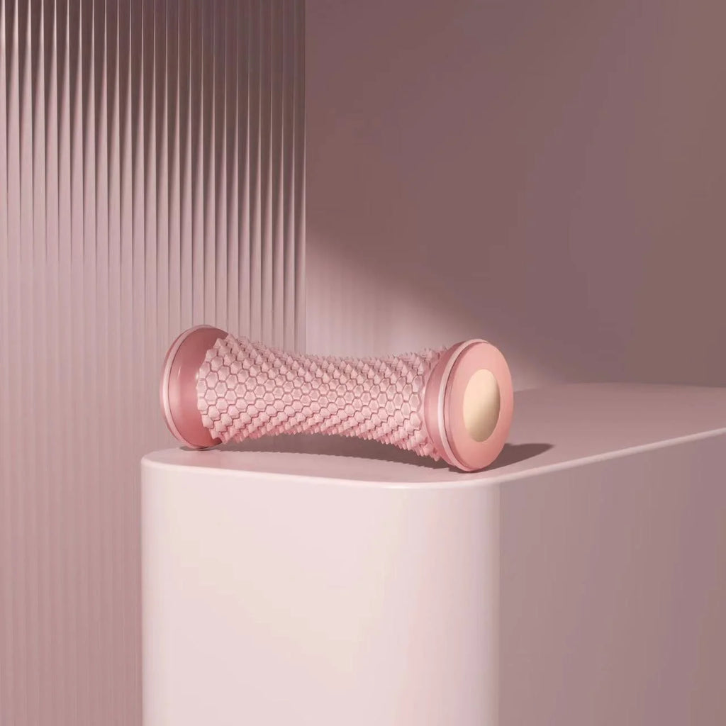Pink manual foot massager roller for relaxation and pain relief