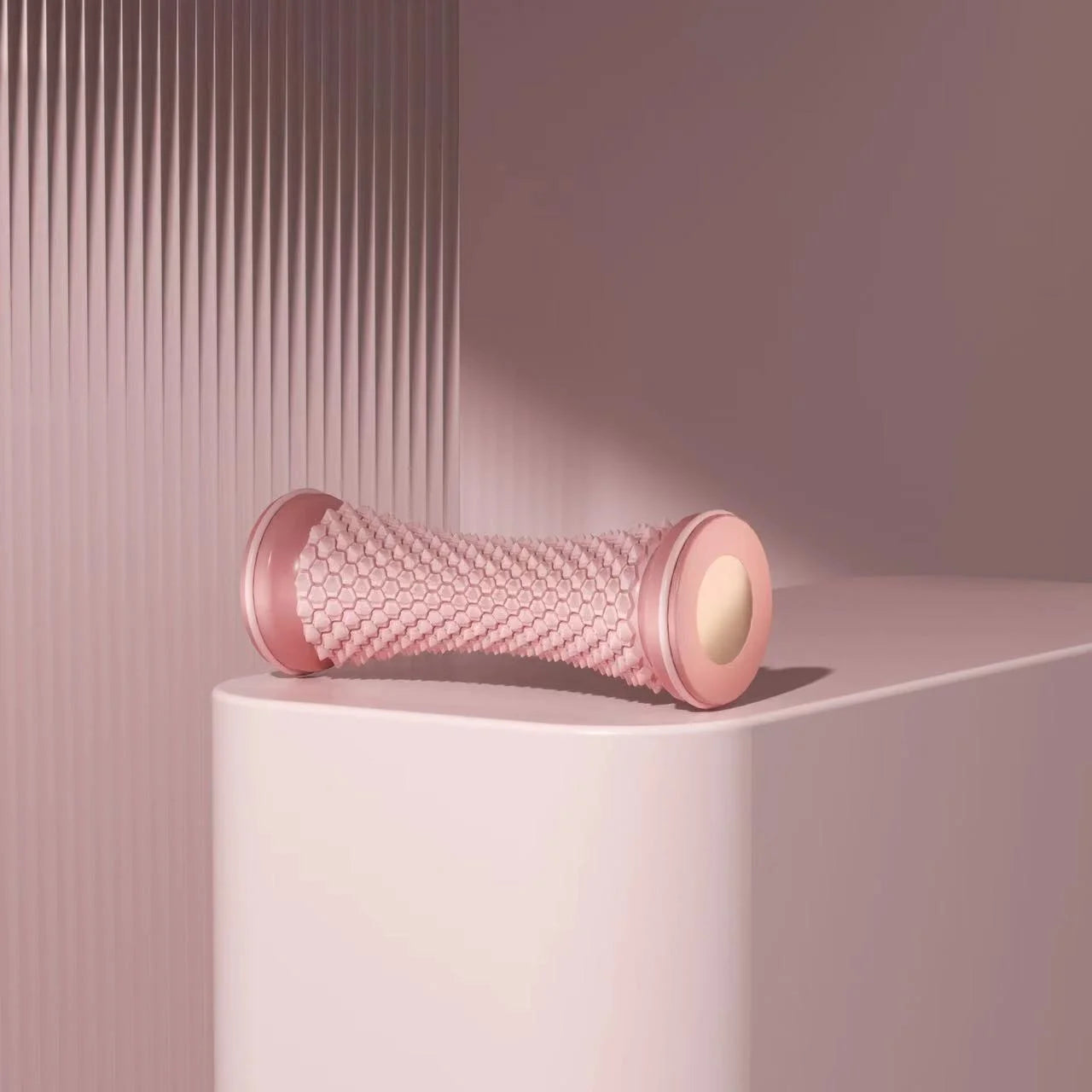 Pink manual foot massager roller for relaxation and pain relief