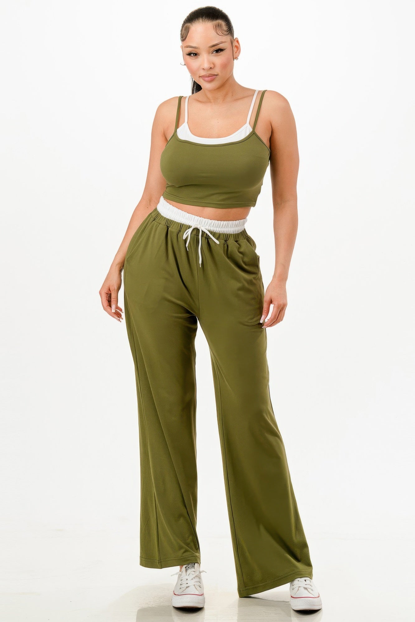 Women wearing olive green matching tank and jogger set with white trim and drawstring waist