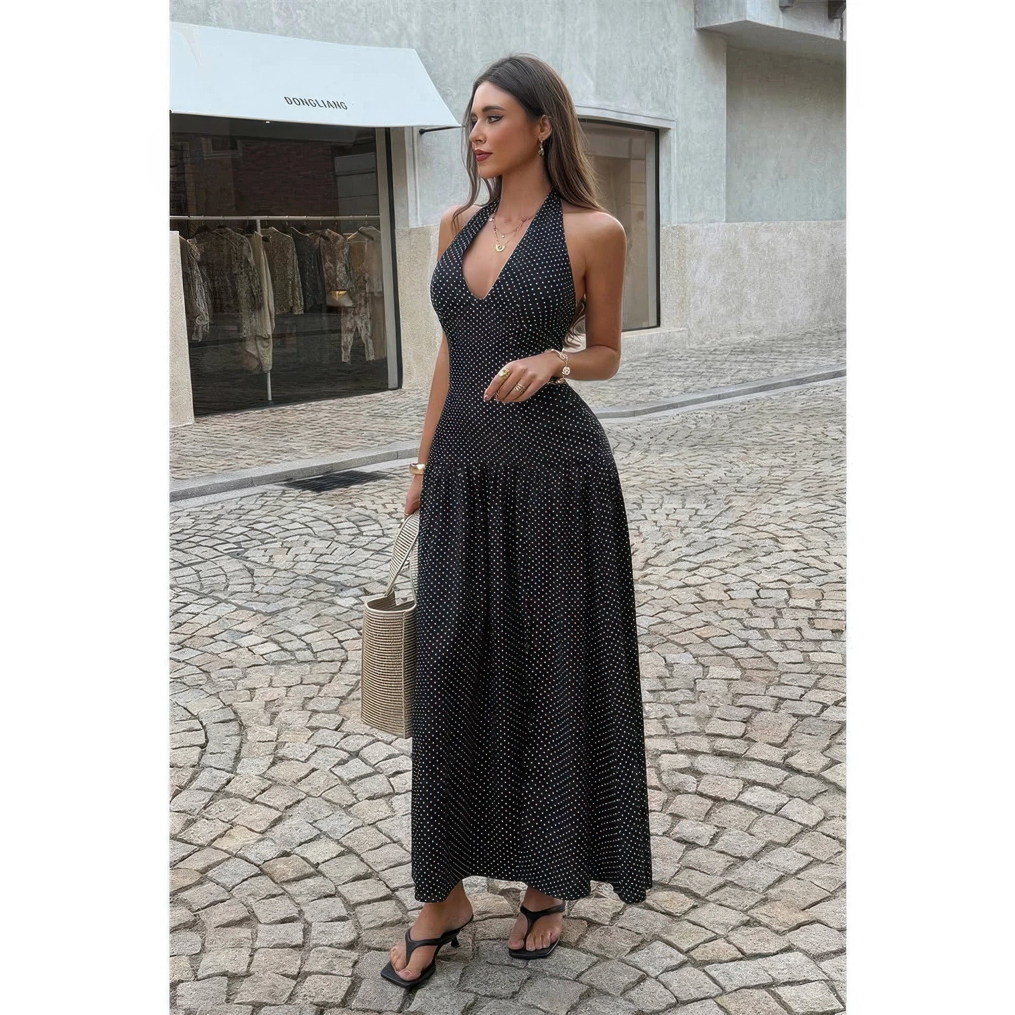 Women's black polka dot halter neck maxi dress, perfect for summer outings.