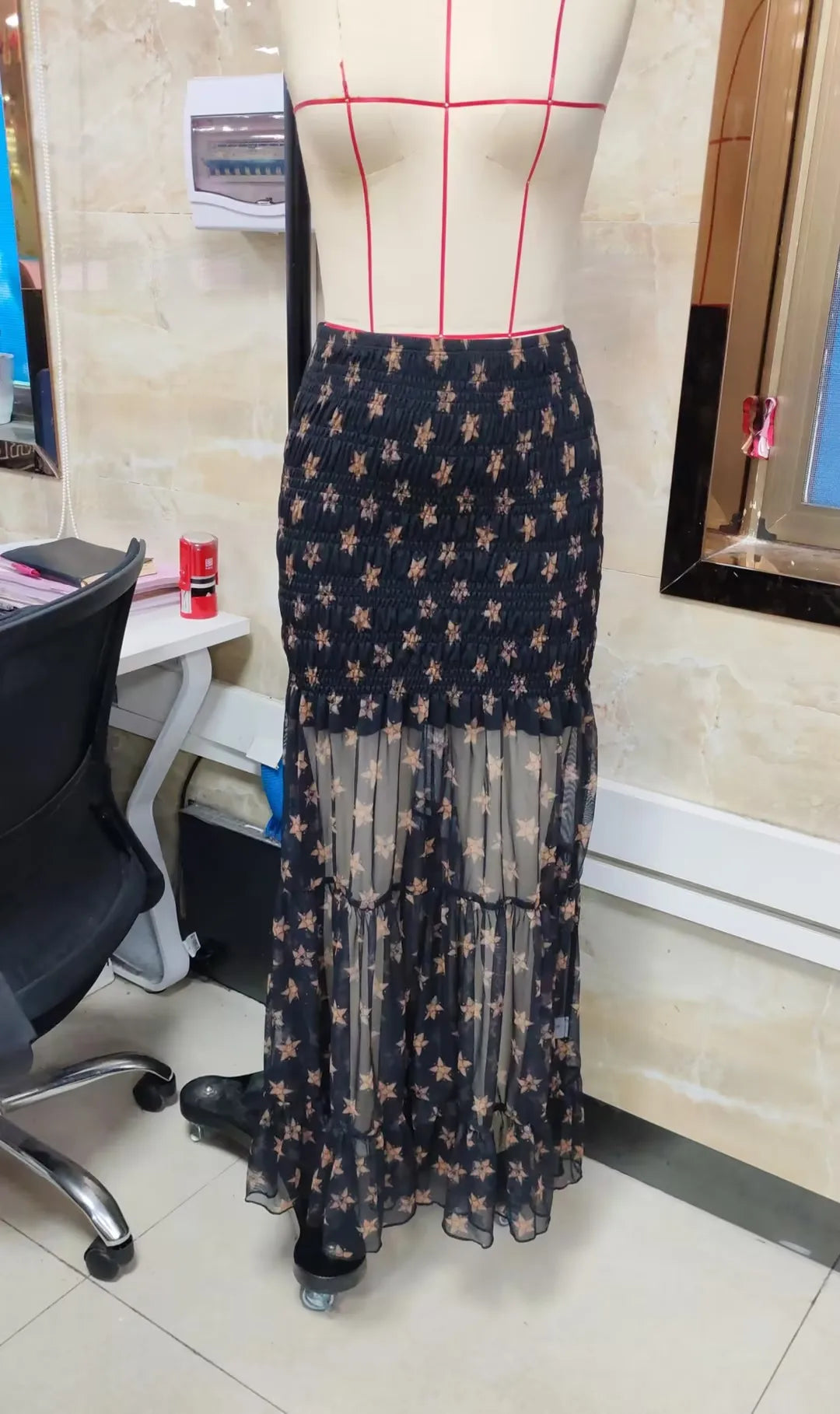 Black floral maxi skirt made of lightweight sheer fabric, perfect for summer outings