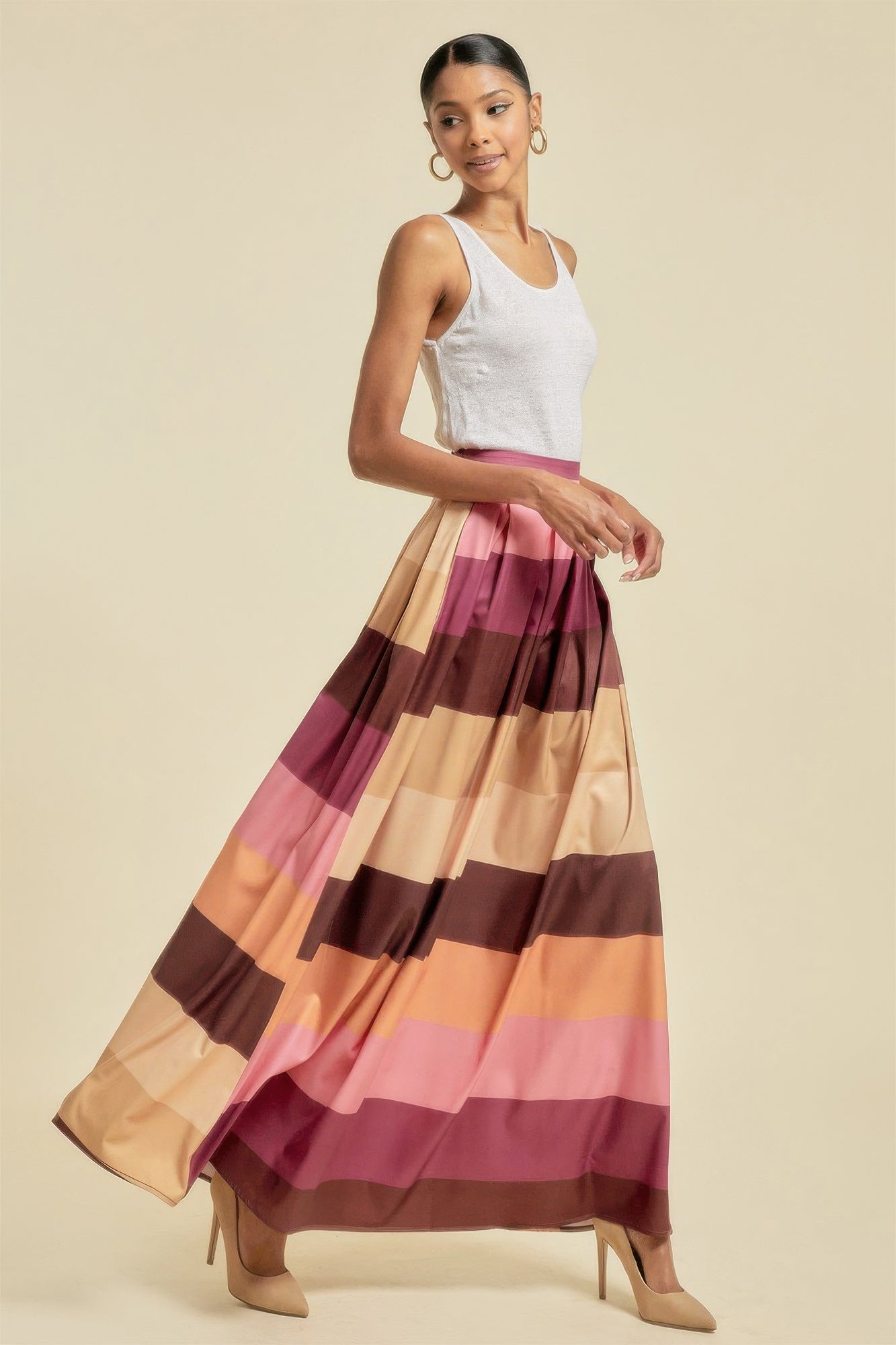 VacationGrabs colorful striped maxi skirt with pockets worn by woman with white tank top and heels