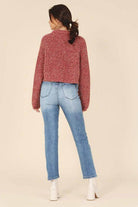 Lilou melange knit sweater in burgundy paired with light denim jeans for a cozy look