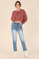 Lilou melange knit sweater in a rich maroon color, paired with light blue jeans for a trendy look