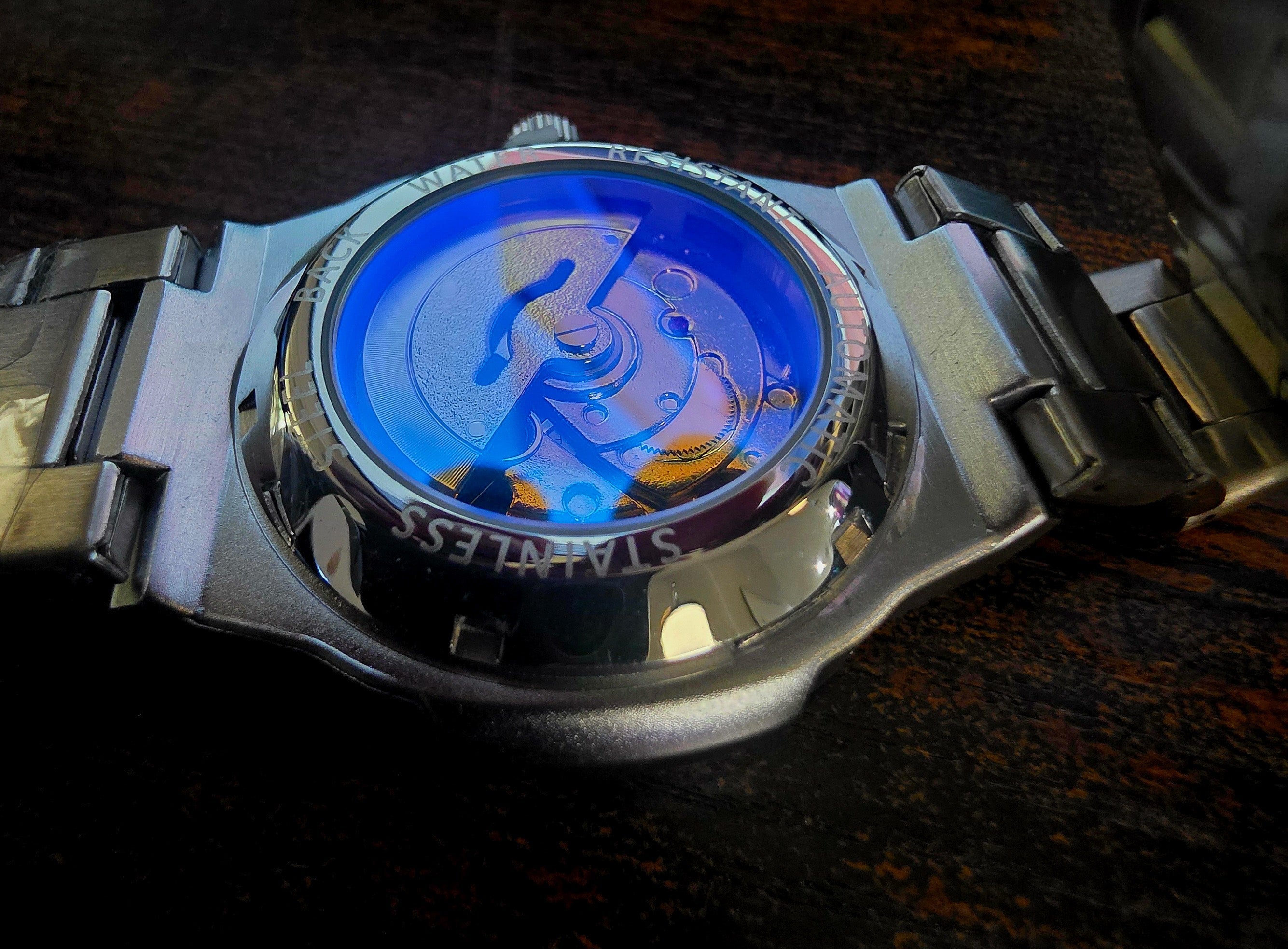 Dapr men's automatic stainless steel watch with transparent case back showcasing intricate movement