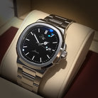 Dapr men's automatic stainless steel watch with a black dial and silver strap in a display box