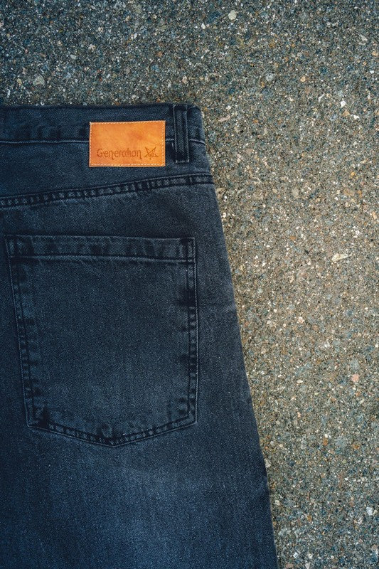 Close-up of Generation XYZ mens baggy fit jeans in dark wash showing back pocket and brand label