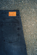 Close-up of Generation XYZ mens baggy fit jeans in dark wash showing back pocket and brand label