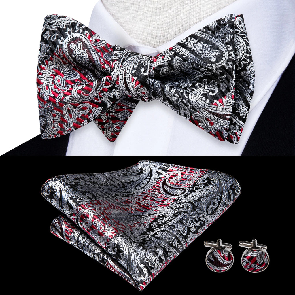 Mens bow tie in red and black paisley pattern with matching pocket square and cufflinks