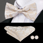 Men's bow tie in cream with elegant gold swirls, perfect for formal occasions