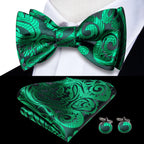 Mens bow tie in green silk with intricate floral design for formal events