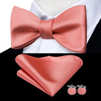 Mens bow tie in coral silk with matching pocket square and cufflinks