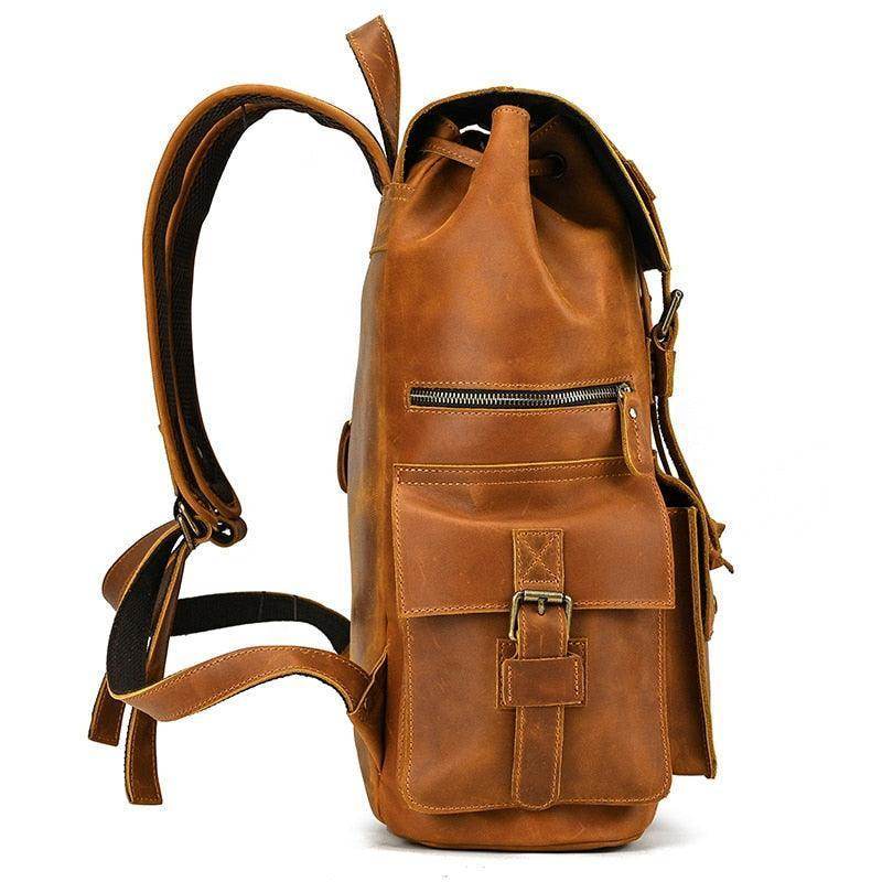 Mens brown leather backpack with adjustable straps and multiple pockets for convenience