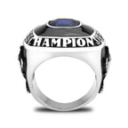 Men's championship rings featuring a blue gemstone and bold champion engraving in silver
