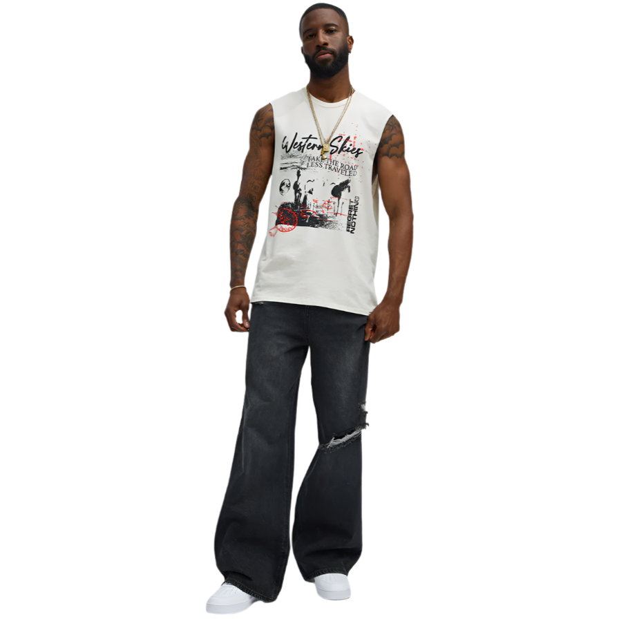 Mens graphic sleeveless shirt in white with black and red design worn with ripped black jeans and white sneakers