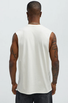 Back view of a mens graphic sleeveless shirt in white worn by a tattooed male model