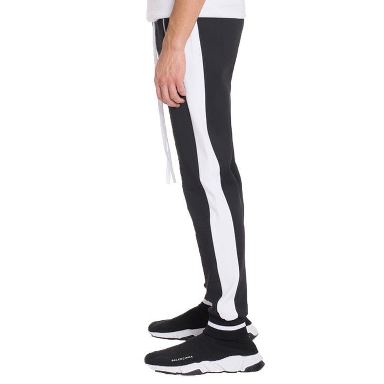 WEIV mens jogger sweatpants in black with white side stripes worn with black sneakers