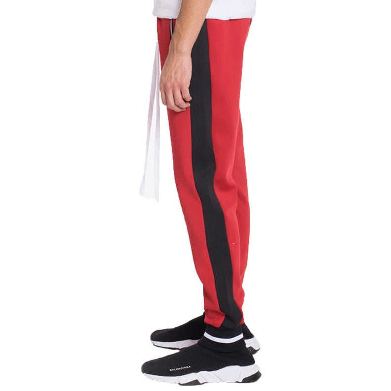 WEIV mens jogger sweatpants in red with black side stripe worn with black sneakers