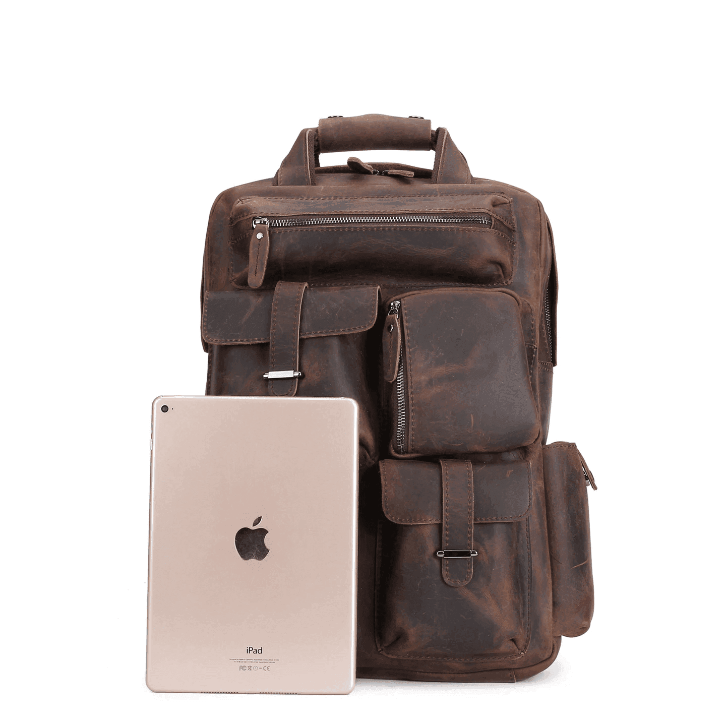 Mens leather backpack large in brown with multiple pockets and an iPad beside it for size reference
